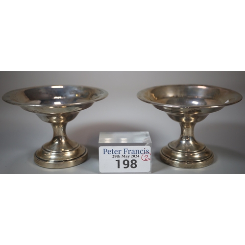 198 - Pair of silver circular bonbon dishes on loaded bases.  Birmingham hallmarks.  9cm diameter approx. ... 