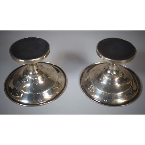 198 - Pair of silver circular bonbon dishes on loaded bases.  Birmingham hallmarks.  9cm diameter approx. ... 