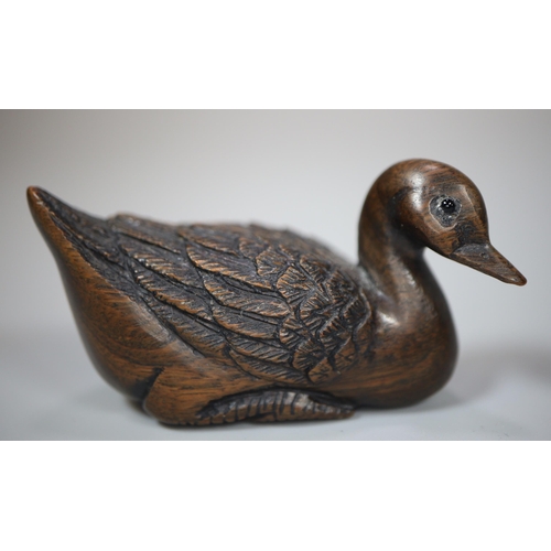 208 - Two good quality carved wooden netsukes, in the form of a duck with character marks to the underside... 