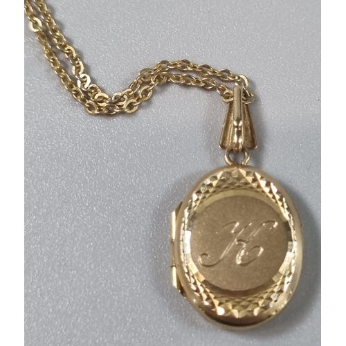 222 - 9ct gold engraved locket on a yellow metal fine link chain. Total weight 3.9g approx. (B.P. 21% + VA... 