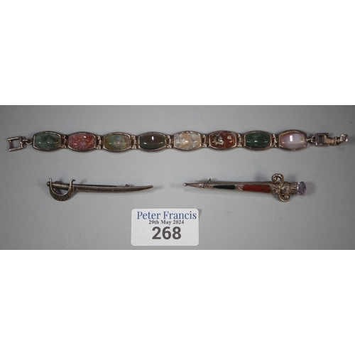 268 - Scottish hardstone dirk kilt pin, cutlass sword brooch and hardstone bracelet.  (3)  (B.P. 21% + VAT... 