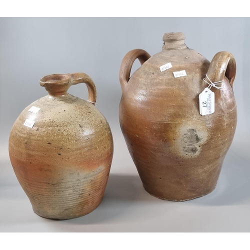 27 - Rustic stoneware two handled flagon together with another stoneware single handled flagon.  The tall... 