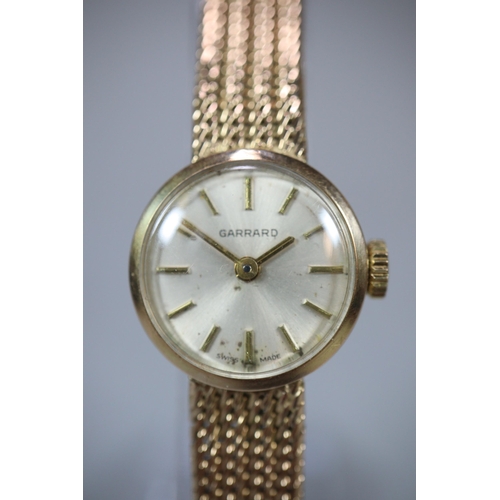 274 - 9ct gold Garrard ladies bracelet watch with satin face, having Baton numerals and integral mesh brac... 