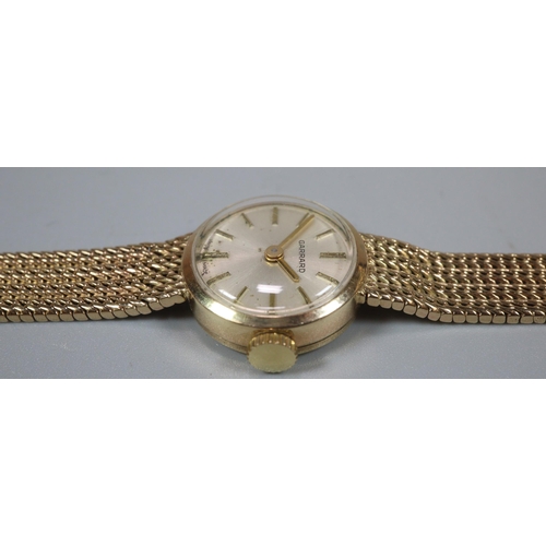 274 - 9ct gold Garrard ladies bracelet watch with satin face, having Baton numerals and integral mesh brac... 