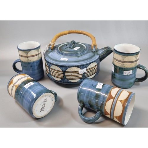 29 - Troika Pottery teapot with bamboo handle and single band of circles, together with a set of four sim... 