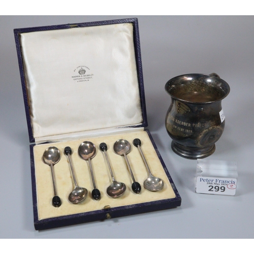 299 - Silver christening mug dated 1929.  3.28 troy oz approx., together with a cased set of six coffee be... 