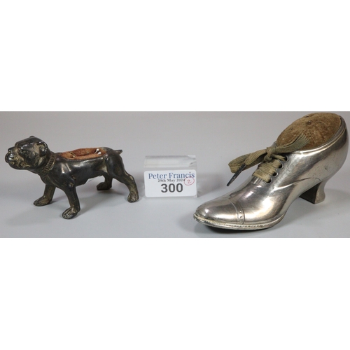 300 - Two novelty pin cushions in the form of a ladies boot and a bulldog.  (2)   (B.P. 21% + VAT)