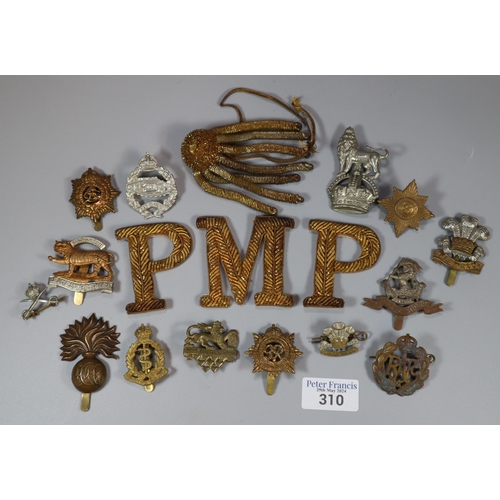 310 - Plastic tub of assorted military cap badges.   (B.P. 21% + VAT)