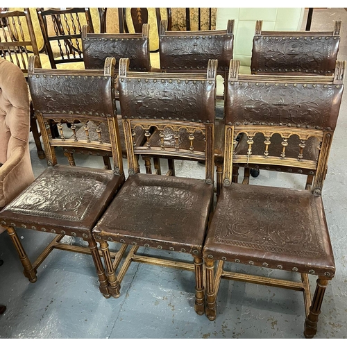 462 - Set of six Edwardian oak dining chairs with gallery backs and stuff-over relief decorated rexine sea... 