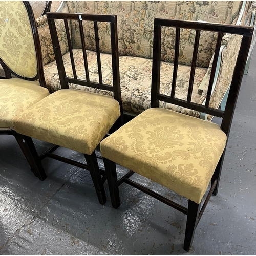 467 - Set of four mahogany framed upholstered dining chairs with oval padded backs and stuff-over seats on... 