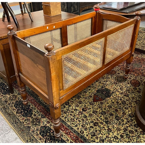 490 - Victorian mahogany cane sided child's cot on baluster turned tapering legs, slatted base.  Provenanc... 