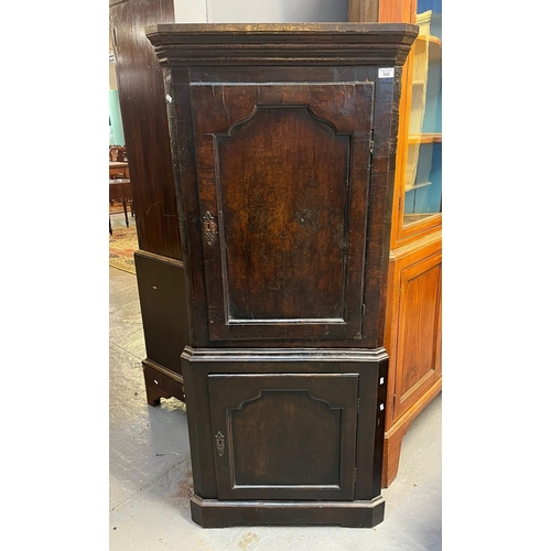 508 - 18th century oak standing double corner cupboard of small proportions with moulded cornice over two ... 