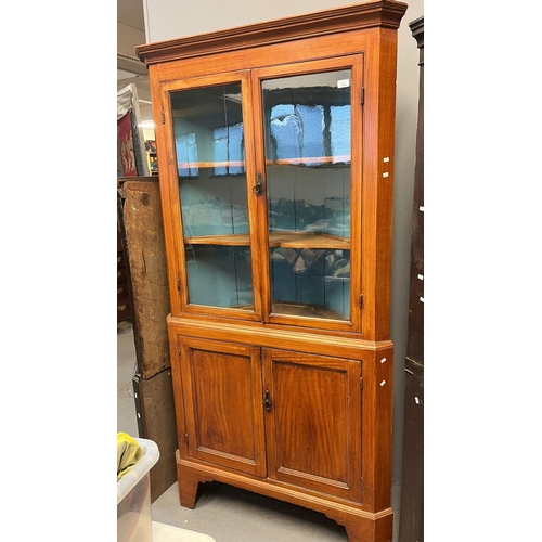 509 - 19th century pine two stage corner cabinet, the interior revealing two shaped shelves and standing o... 