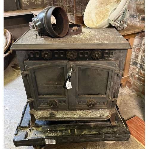 528 - Champion cast iron wood burning stove with two glazed doors.  62cm wide approx.  Provenance: Pembrok... 