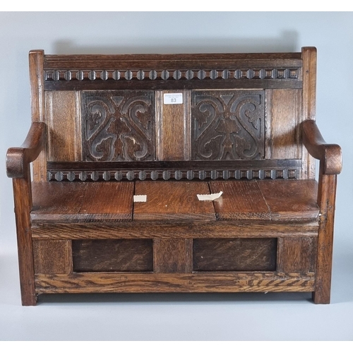 83 - Oak miniature, possibly apprentice piece, settle, the two panelled back with fretwork carvings, open... 