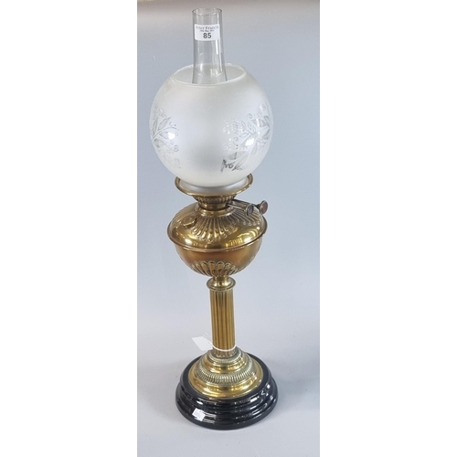 85 - Early 20th century double oil burner lamp having frosted and etched globular glass shade above a bra... 