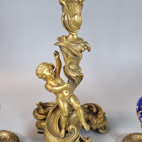 15 - Baroque style bronze ormolu cherub candle stick, together with a pair of gilded candlesticks with ce... 