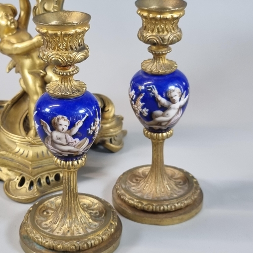 15 - Baroque style bronze ormolu cherub candle stick, together with a pair of gilded candlesticks with ce... 