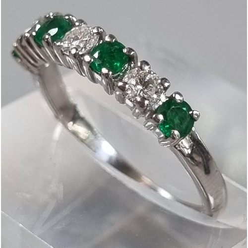 198 - 9ct white gold diamond and emerald seven stone ring.  2.1g approx.  Size K.  (B.P. 21% + VAT)