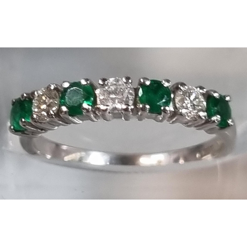 198 - 9ct white gold diamond and emerald seven stone ring.  2.1g approx.  Size K.  (B.P. 21% + VAT)