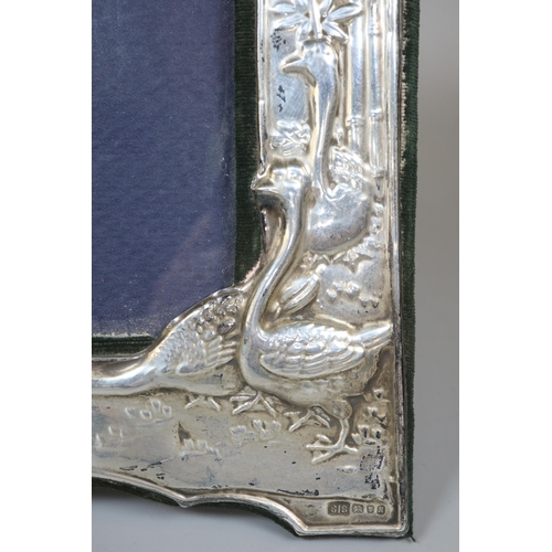 248 - Art Nouveau silver easel picture frame decorated with relief geese and frog.  (B.P. 21% + VAT)