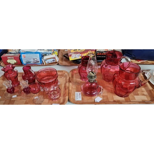 302 - Two trays of mainly 19th century Cranberry glass items to include: single oil burner lamp, jugs, can... 