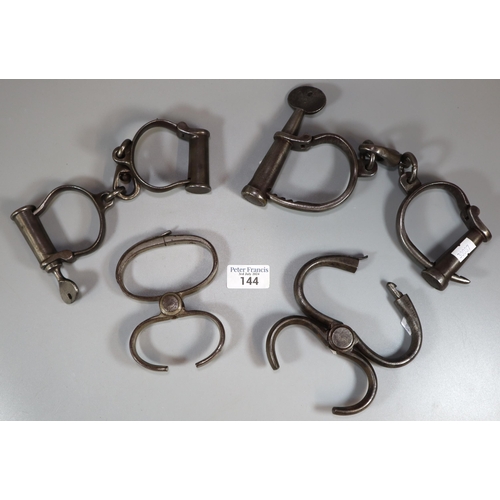 144 - Collection of Victorian handcuffs to include Victorian escort cuffs, male barrel handcuffs and femal... 