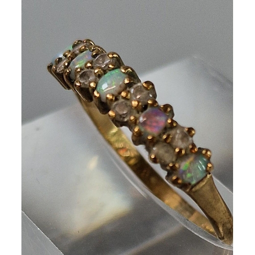 204 - 9ct gold thirteen stone opal and clear stone ring. 1.4g approx. Size M.  (B.P. 21% + VAT)