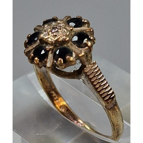 213 - 9ct gold diamond and six stone sapphire flowerhead ring. 3.2g approx. Size M.  (B.P. 21% + VAT)