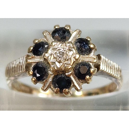 213 - 9ct gold diamond and six stone sapphire flowerhead ring. 3.2g approx. Size M.  (B.P. 21% + VAT)