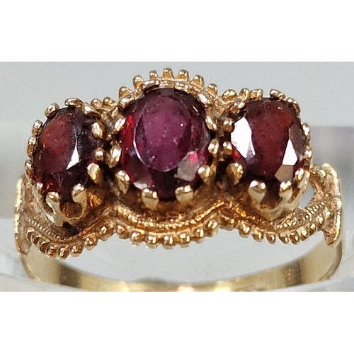 219 - 9ct gold three stone garnet ring, 2.9g approx. Ring size Q (B.P. 21% + VAT)