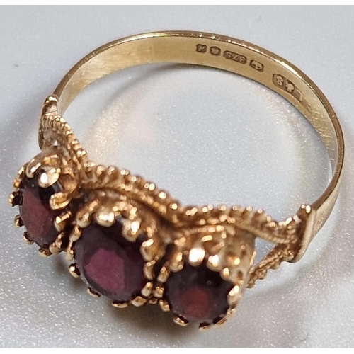 219 - 9ct gold three stone garnet ring, 2.9g approx. Ring size Q (B.P. 21% + VAT)