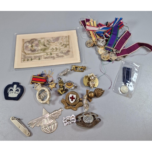 253 - Collection of military items: miniature medals, cap badges, WWI silk postcard etc. (B.P. 21% + VAT)