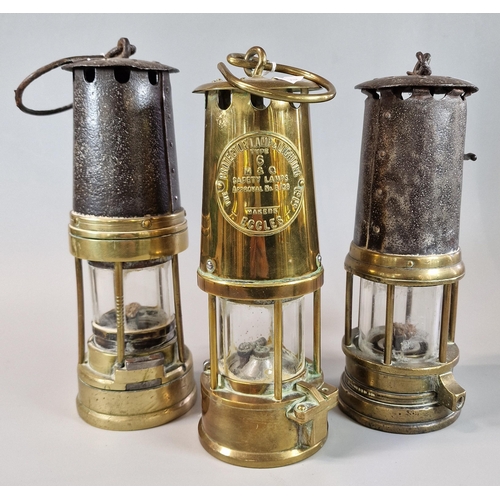 26 - Three vintage brass Miner's lamps, one marked 'Protector Lamp Lighting Co Ltd Eccles'.  (3)  (B.P. 2... 