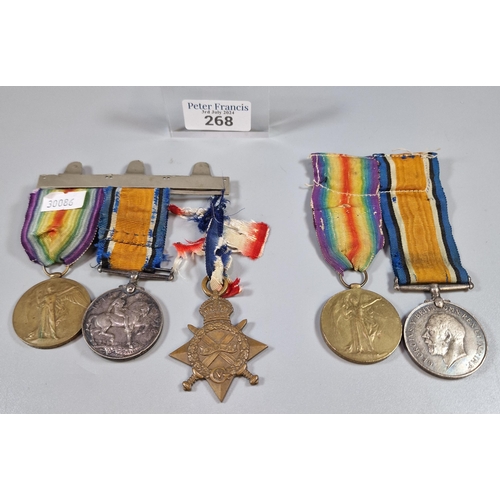 268 - Two First World War medal groups to include: Medal trio awarded to Private W. John AOC number 010548... 