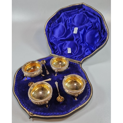 270 - A cased set of Edward VII silver circular salts on hoof feet with gilt lining and spoons, by Josiah ... 