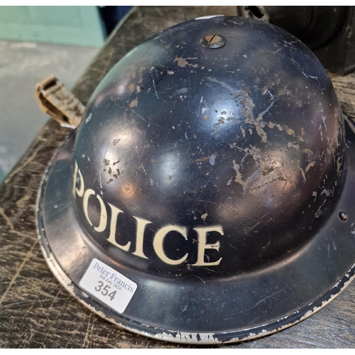 354 - WWII period policeman's metal helmet with interior and chin strap. (B.P. 21% + VAT)