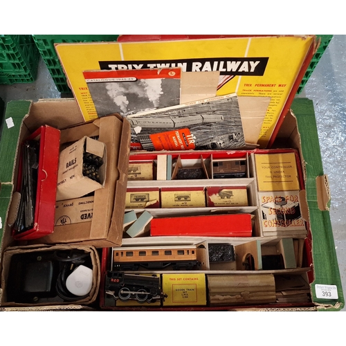 393 - Box of Trix twin railway OO scale items to include: rails, plank and open wagons, locomotives, goods... 