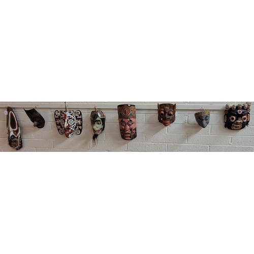 400 - Collection of eight hand-carved wooden and polychrome decorated African and Asian traditional tribal... 