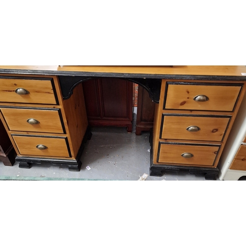 422 - Modern pine and ebonised kneehole desk, having a bank of three drawers to each pedestal, 147cm long ... 