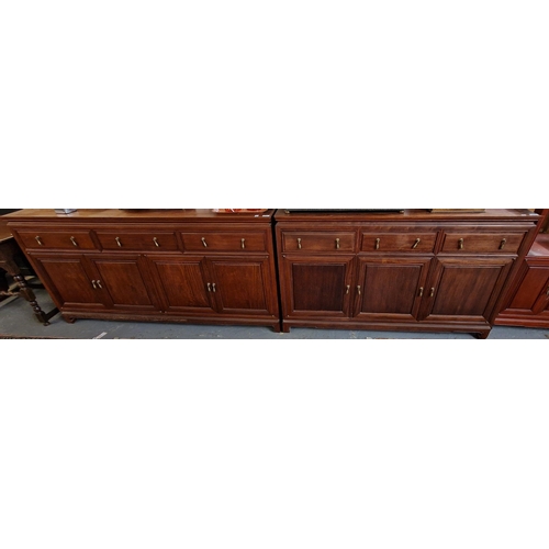 428 - A pair of 29th century Chinese hardwood sideboard bases each with three moulded frieze drawers over ... 