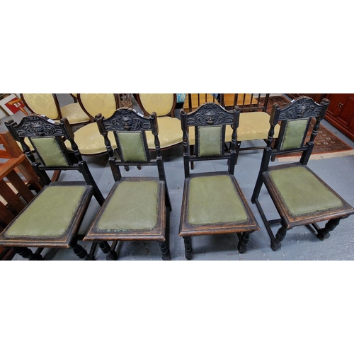 442 - Set of four late Victorian carved oak dining chairs, the back rail decorated with carved moulded 'Gr... 