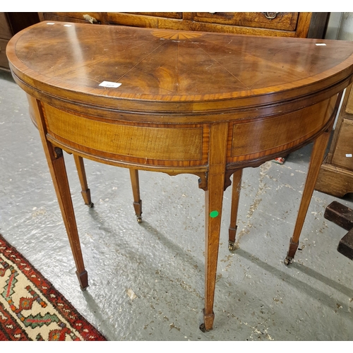 469 - 19th century mahogany inlaid demilune folding card table on square tapering legs and castors (B.P. 2... 