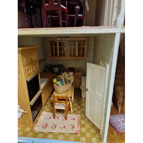 476 - A wooden Georgian style three storey dolls house, the interior revealing furniture, other accessorie... 