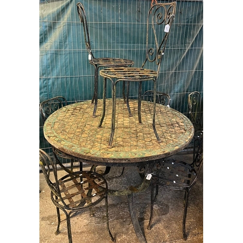 497 - Rustic mosaic geometric circular top and cast metal garden table with a set of six weathered garden ... 