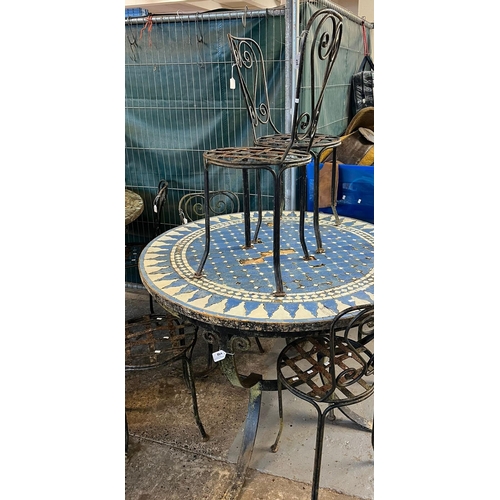 498 - Rustic mosaic geometric circular top in Islamic style and cast metal garden table with a set of six ... 