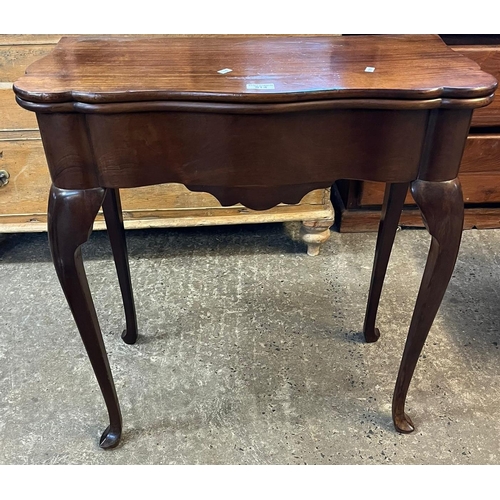 514 - An 18th century mahogany fold over card table, the moulded and shaped serpentine top above a plain f... 