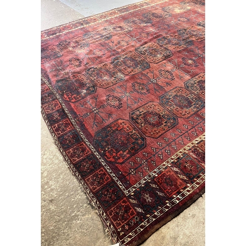 517 - An antique Heriz geometric floral and foliate runner together with a red ground Takkemen Turkmen car... 