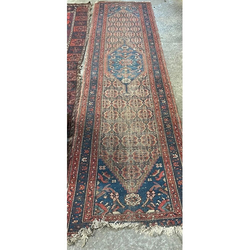 517 - An antique Heriz geometric floral and foliate runner together with a red ground Takkemen Turkmen car... 