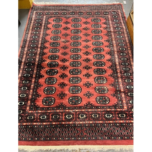 524 - Three similar vintage Afghan carpets on green, beige and red grounds with similar repeating geometri... 